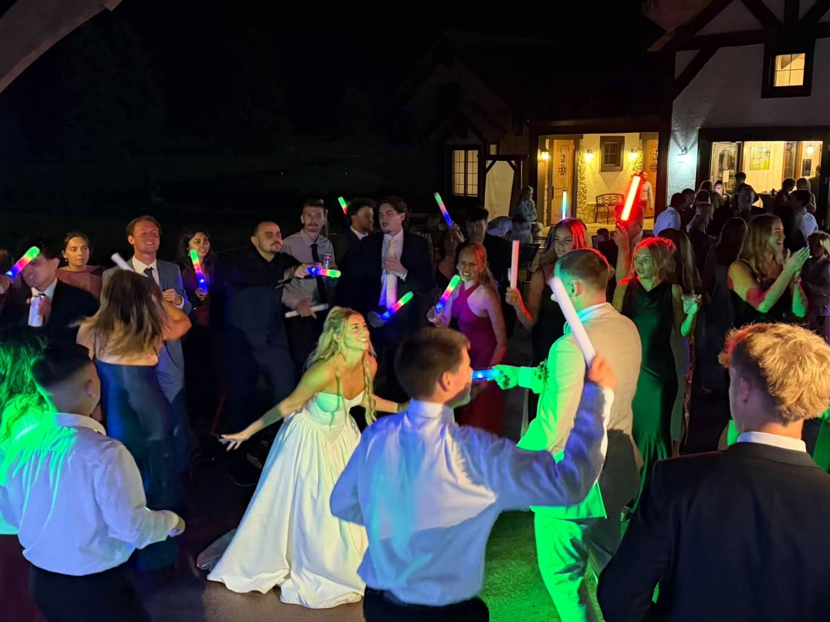 Bride and groom dancing with their friends