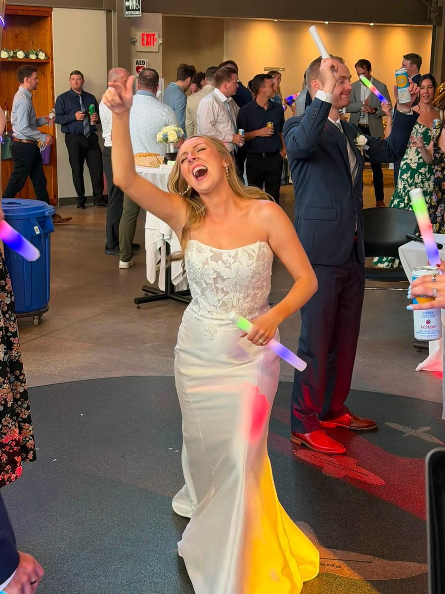 A bride singing along on the dance floor